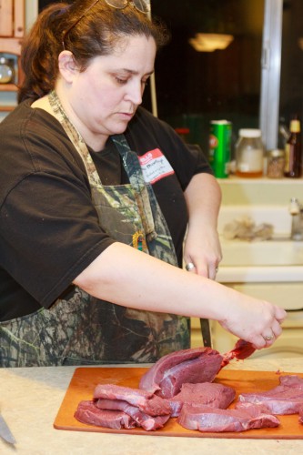 Colleen is cutting steaks from the bottom round of Elk.